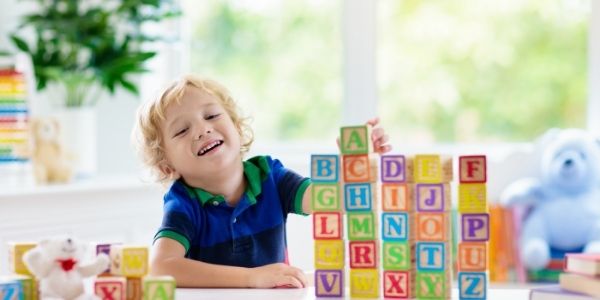 little boy playing letter blocks