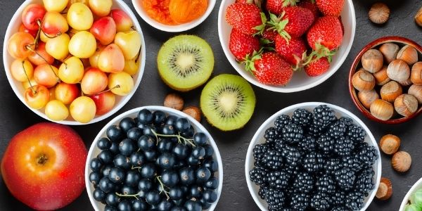 bowls of fruits and nuts on a table