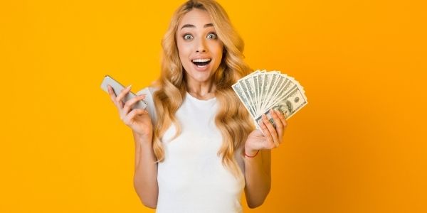 lady holding cellphone and money