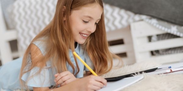 girl writing in notebook
