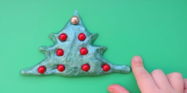 slime in form of christmas tree with red balls in it