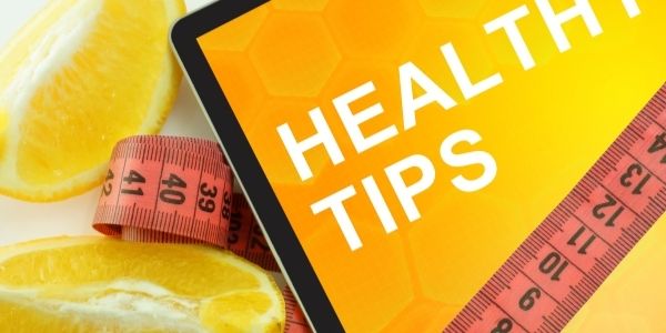 tablet with the words Health tips on it and a tape measure wrapped around it