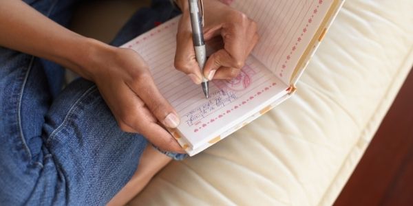 persona writing in their journal