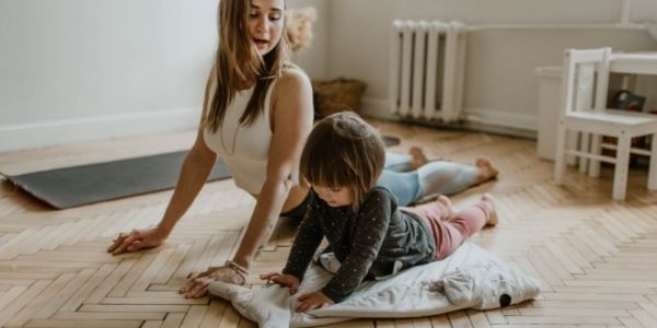 mom exercising with her son doing yoga