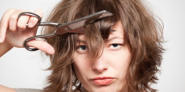 lady cutting her own hair