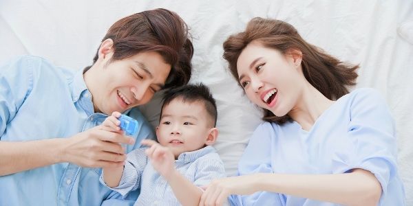 mom and dad playing with child