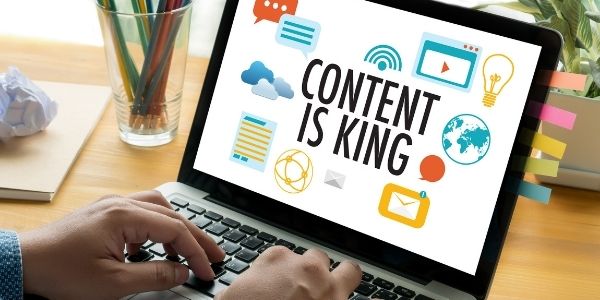 laptop with a page saying content is king